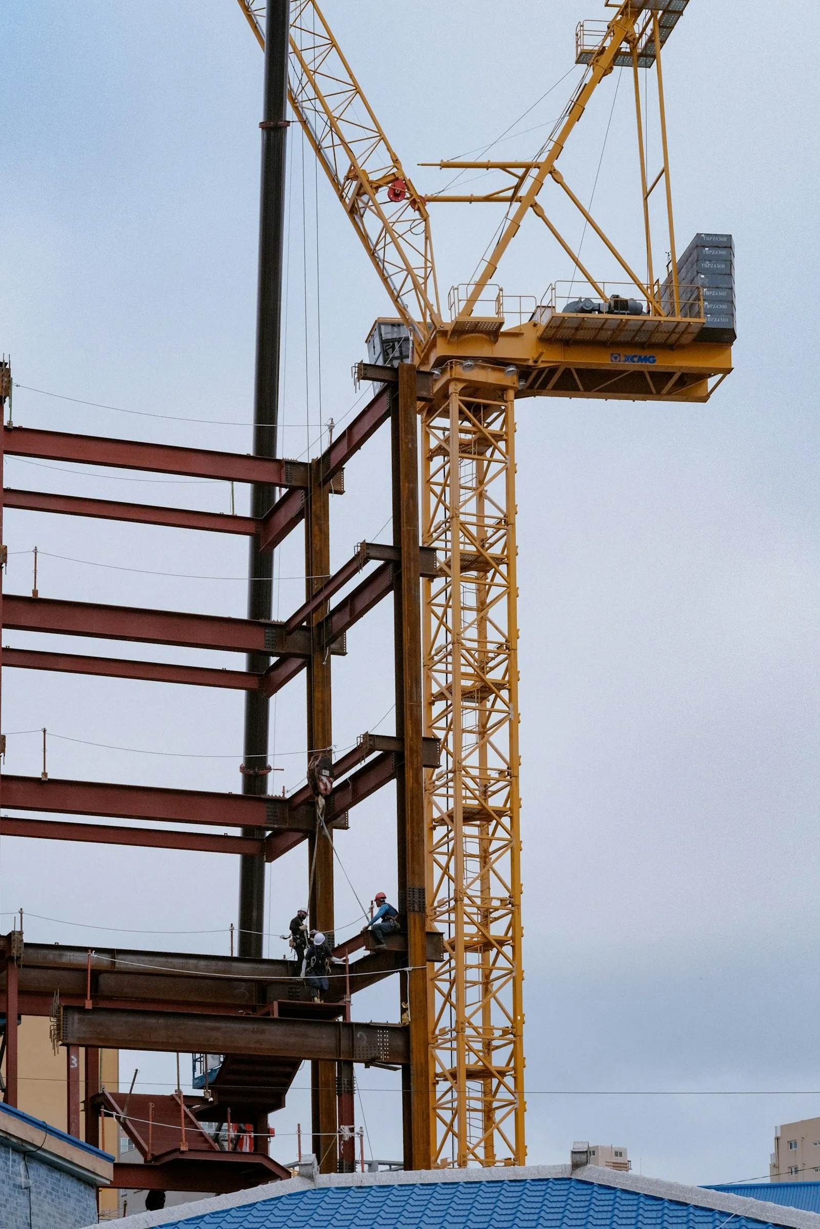 A construction site with a tower crane and steel frame structure