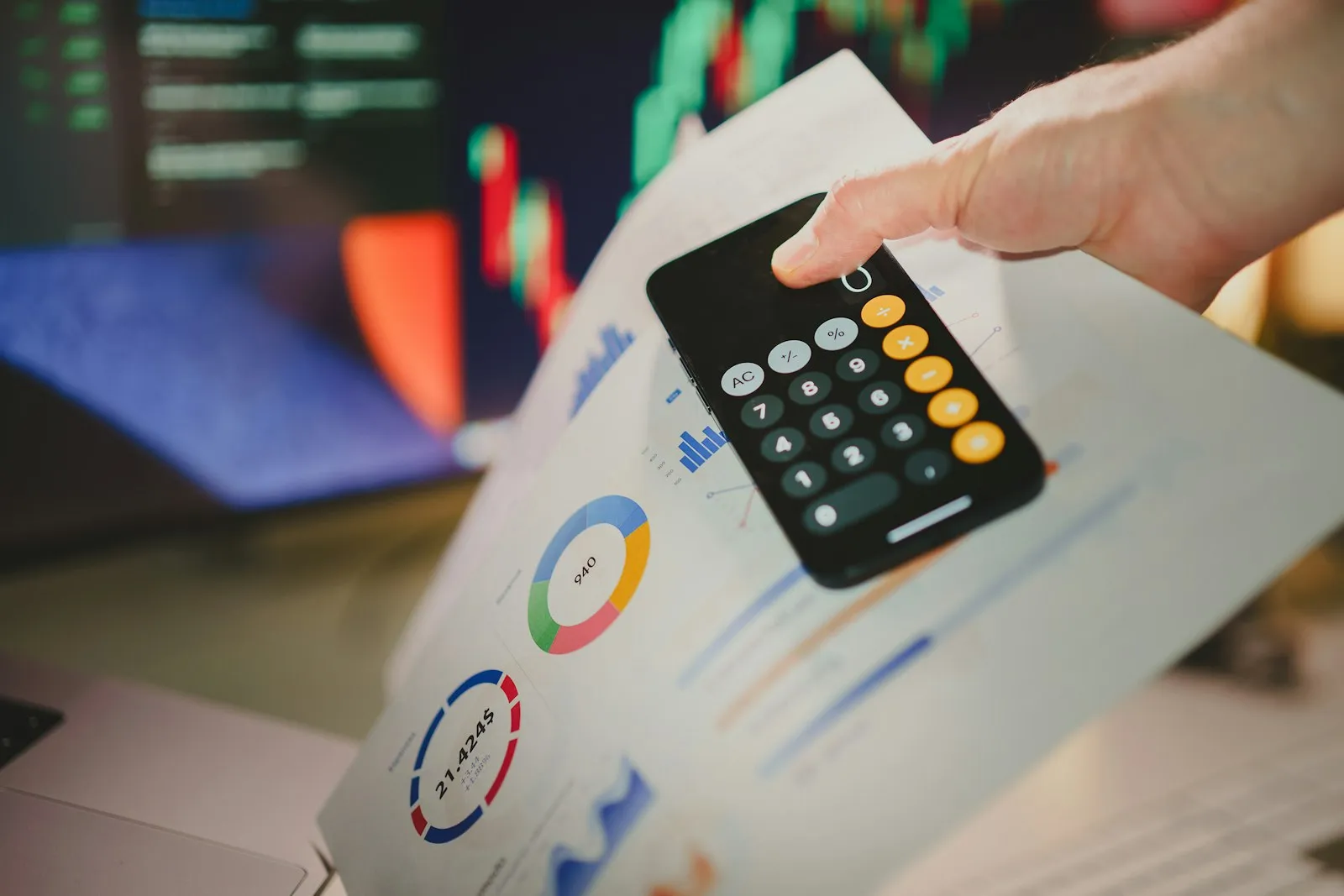 A person reviewing financial charts and calculating figures