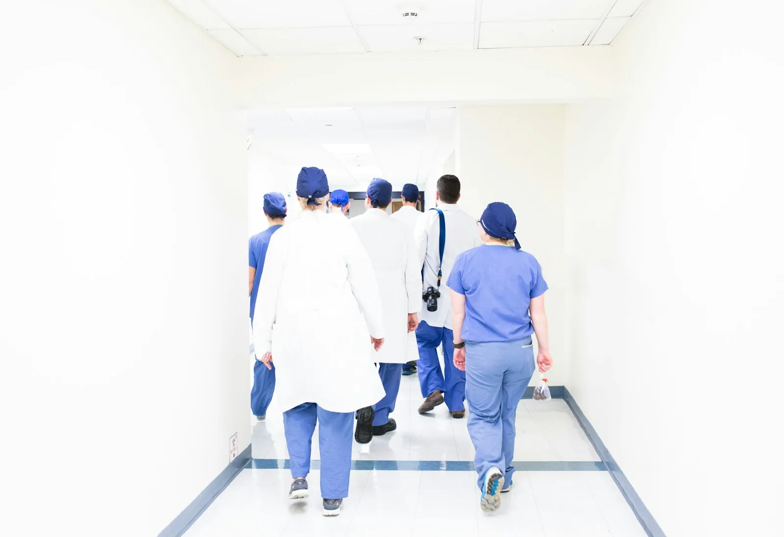 A team of medical professionals walking through a hospital hallway