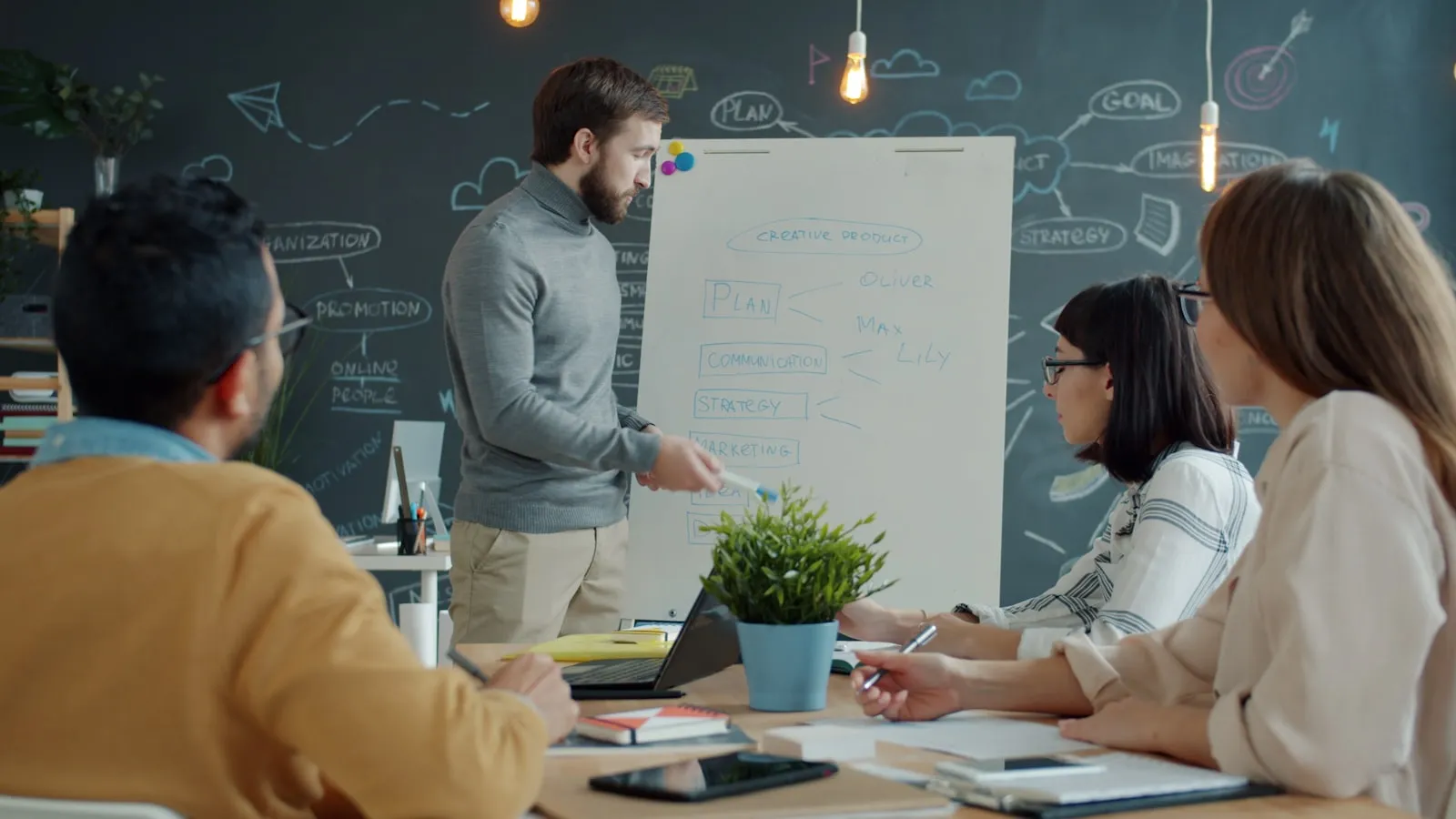 A consultant leading a team through strategy planning on a whiteboard